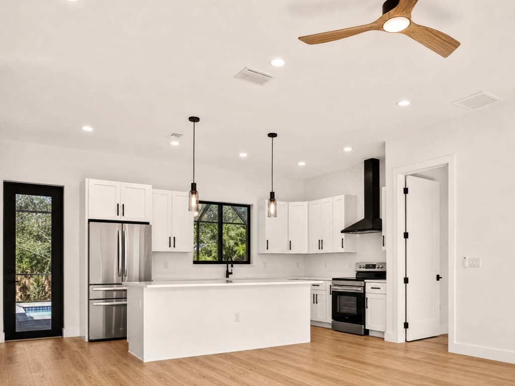Renovated open-plan kitchen with island by Sosnin Builders